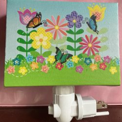 Nightlight with flowers and butterflies. Vinyl fabric over wood. Swivel base w on-off switch. Bulb included. Excellent cond. Free shipping.