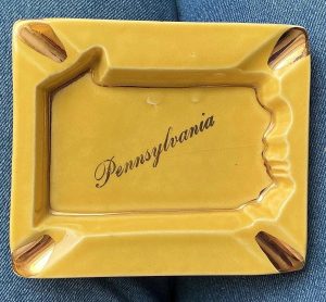 F & M Artware Pennsylvania handmade ceramic ashtray in gold w warranted 22kt. gold accents. 1950s. Base shaped like PA. 4”x3”. Free ship.