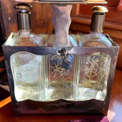 Tilso tantalus:3 decanters w gold swirls. Locks,key included. Music box plays”How Dry I Am.” (Needs adjustment.) Brass and glass.Free ship.