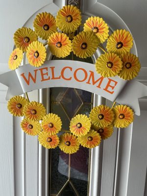 Sunflower “Welcome” Metal Wreath. Sturdy. Bright addition to your front door or anywhere you need a bit of sunshine.18”by 15.”Free shipping.